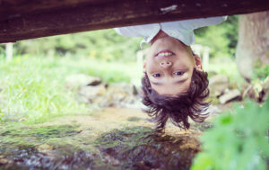 Kid looking under bridge