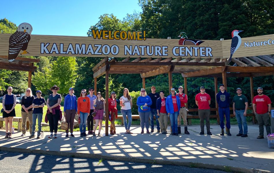 group in front of nature center sign