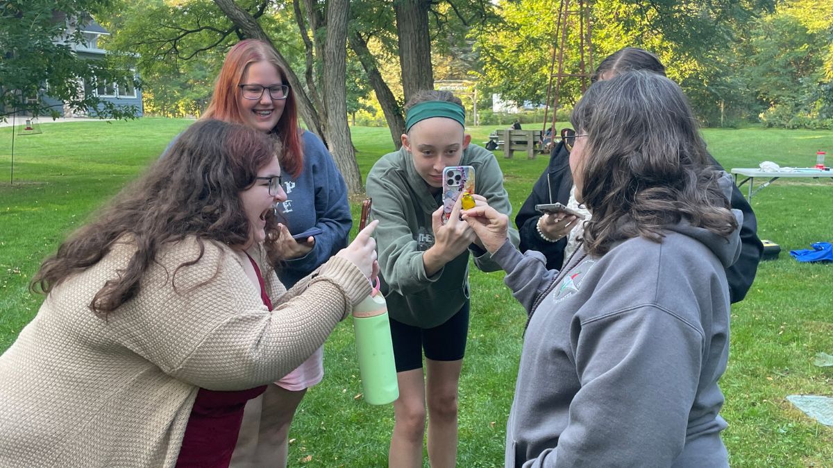 students watching research team banding birds