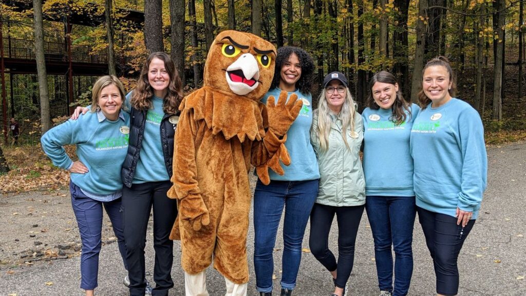School teachers standing with raptor mascot
