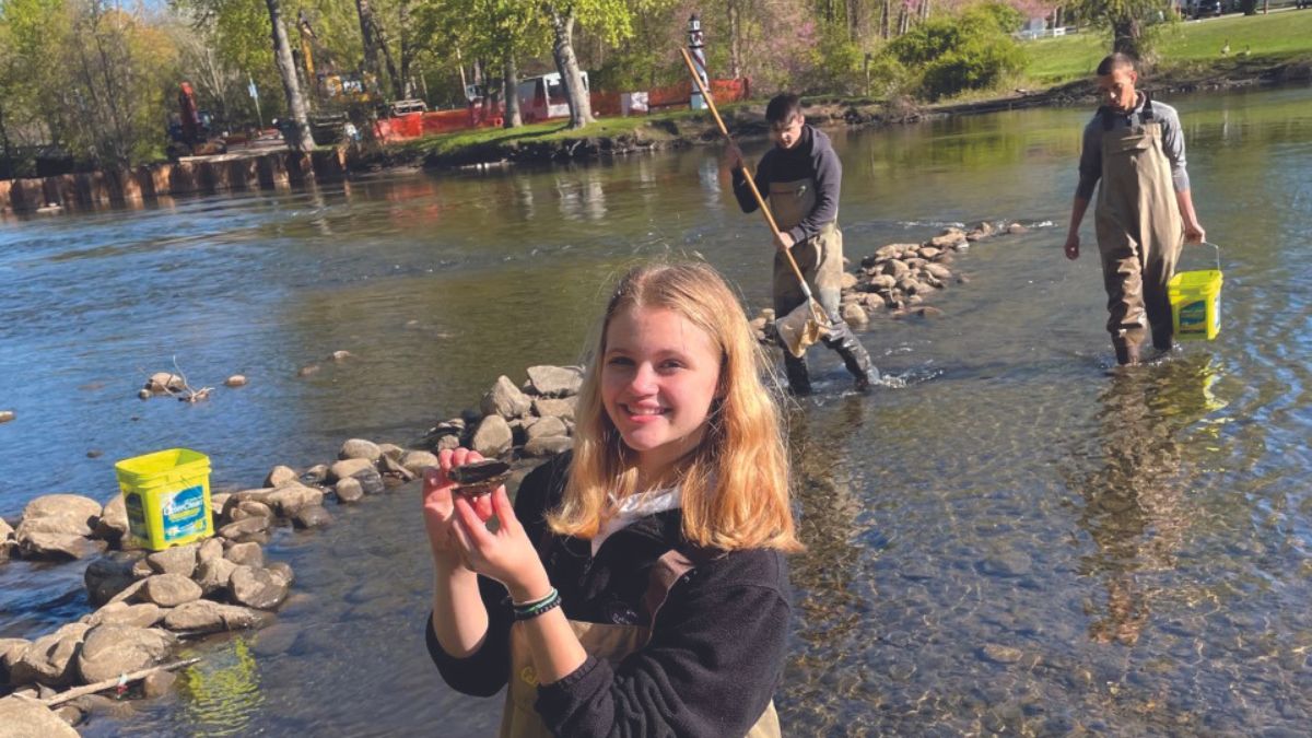 researchers standing in river