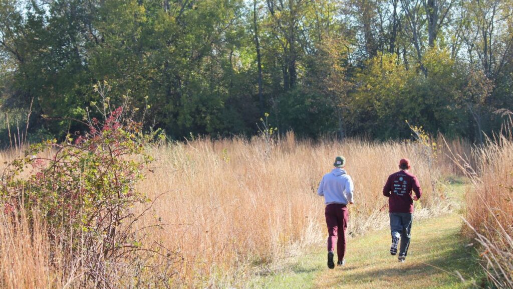 people running through fall prairie