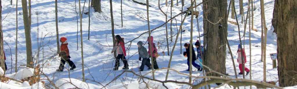 Kids hiking in snow in winter